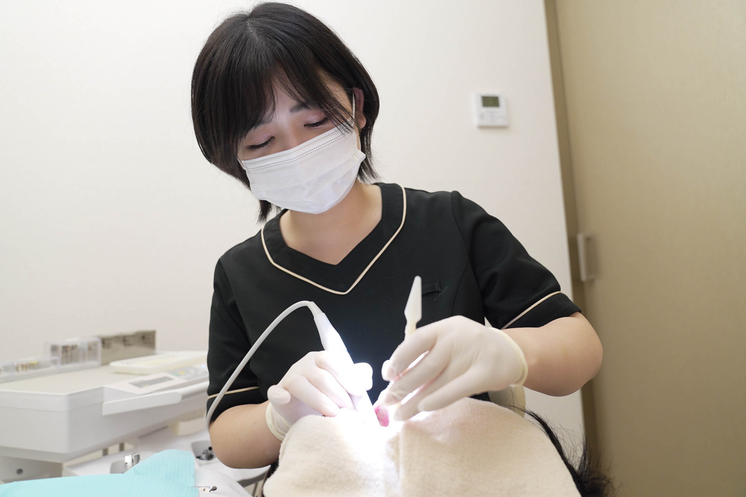 Dental hygienist performing treatment